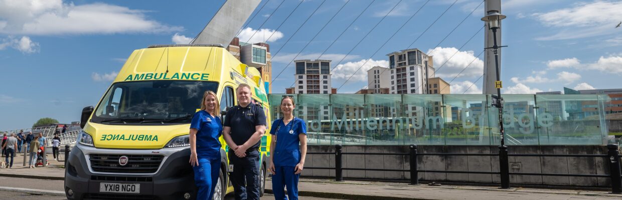 NECTAR ambulance team stood with yellow NECTAR ambulance on the quayside