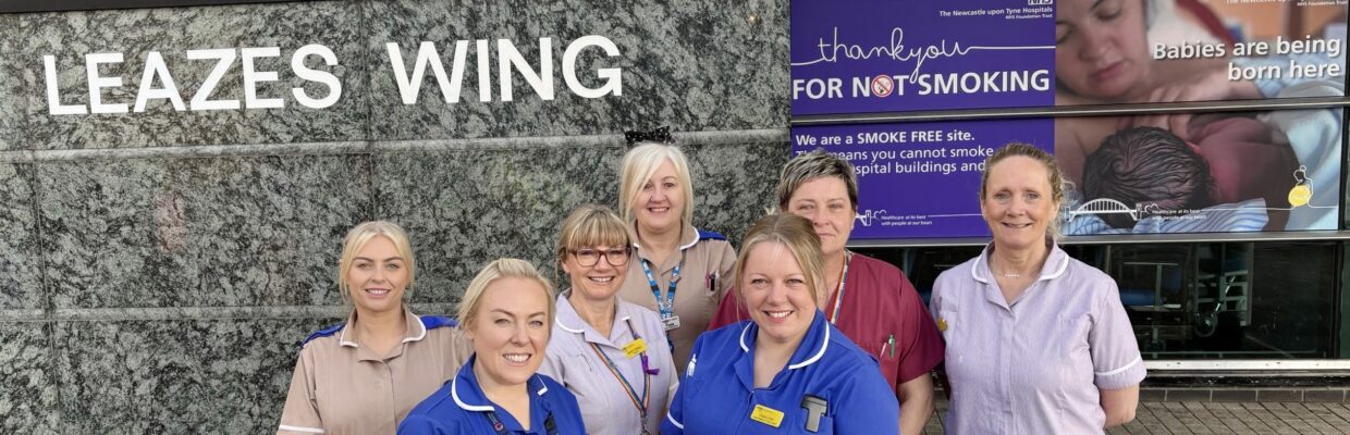 Picture of a group of midwives outside the Leazes Wing with the new no smoking signage on display.